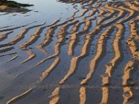 Sandwellen und Wasser an der Constantine Bay